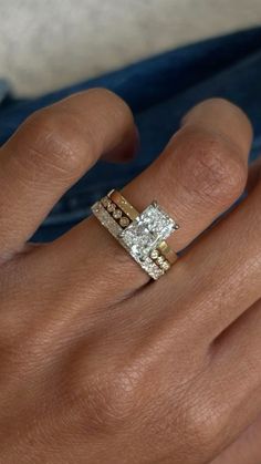 a woman's hand with a diamond ring on it