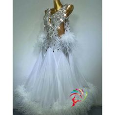 a white dress with feathers and sequins