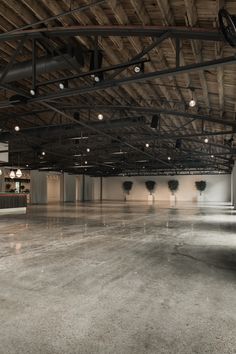 an empty room with several lights on the ceiling and no people in the area around it