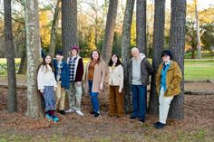 a group of people standing next to each other in the woods