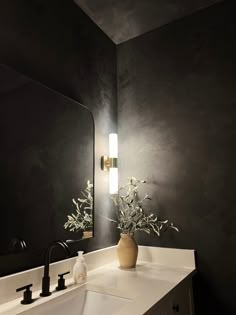 a white sink sitting under a bathroom mirror