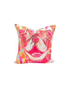 a decorative pillow with a dog's face on the front and sides, in bright colors