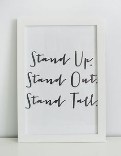 a black and white photo with the words stand up, stand out, stand tall