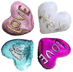 four heart shaped candies with the word love on them in different colors and designs