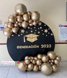 there is a graduation sign with gold balloons in front of it