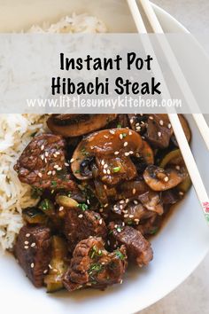 a white bowl filled with beef and mushrooms next to chopsticks on top of rice