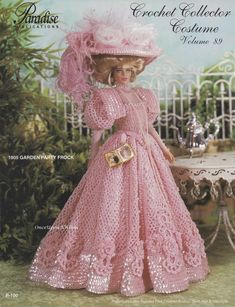 a crocheted doll in a pink dress and hat