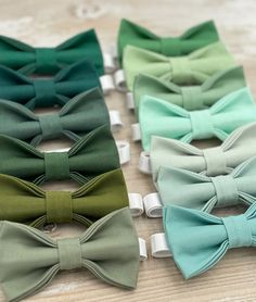 four different colors of bow ties sitting on top of a table