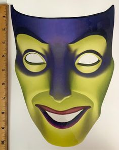 an image of a mask that looks like it is wearing a green and purple face