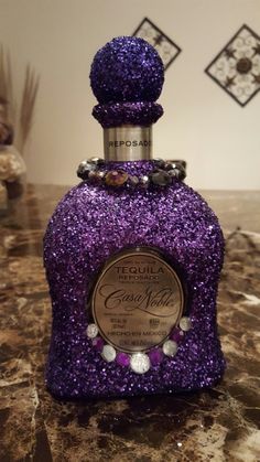 a purple bottle sitting on top of a counter