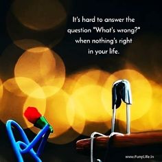 there is a small red object sitting on top of a piece of wood with the words, it's hard to answer the question what's wrong when nothing's right in your life