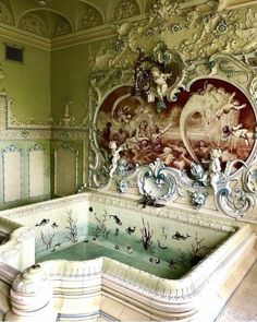 an ornately decorated bathtub in the middle of a room