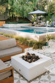 an outdoor fire pit in the middle of a patio