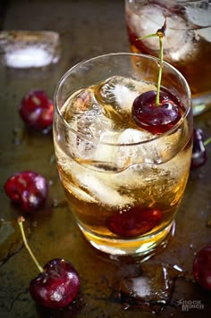 two glasses filled with ice and cherries