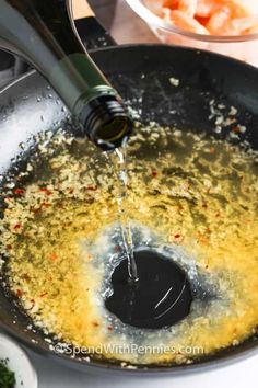 a frying pan filled with oil and vegetables