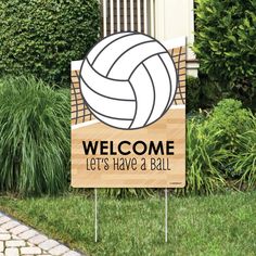 a welcome sign with a volleyball on it in front of some bushes and shrubs,