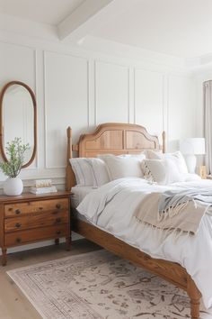 a bedroom with white walls and wooden furniture