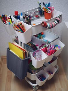 the cart is filled with lots of office supplies and stationery on it's wheels