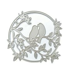 two birds sitting on a tree branch in front of a white circle with leaves and flowers