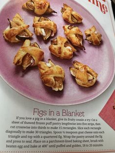 a pink plate topped with pieces of food on top of a magazine article about pigs in a blanket