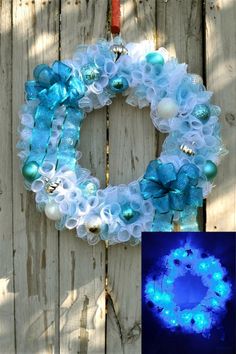 a wreath with blue and white decorations hanging on a wooden fence next to an image of a christmas ornament