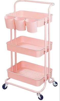 a pink cart with three cups on it and two trays attached to the side