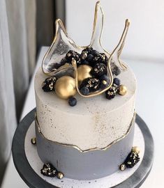 a white cake with gold decorations on top