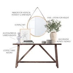 a wooden table topped with a mirror and vase next to a plant on top of it