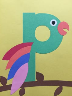 the letter p is made out of paper with a colorful bird on it's back