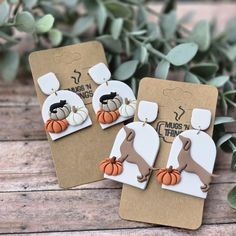 two pairs of earrings with pumpkins on them