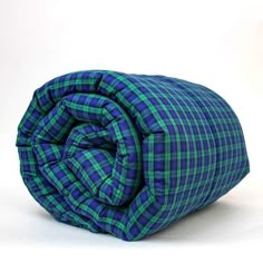 a blue and green plaid comforter on a white background