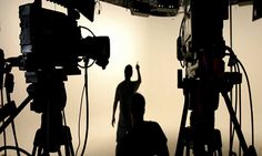 a man standing in front of a camera with the words photo production los angeles