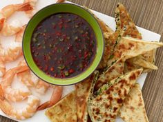 shrimp, tortilla chips and salsa on a plate