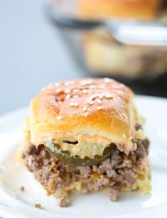 a close up of a sandwich on a plate with other food items in the background