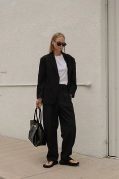 Intended to be worn everyday, the Bobbi Blazer is a minimalist wardrobe essential. It's relaxed but tailored silhouette produces a soft structure that not only flatters the body, but allows for additional layering underneath. The Bobbi Trousers feature a high-waist, straight leg silhouette with pleats at the waistband. The relaxed leg allows for additional comfort in the movement of everyday life. Oversized Lapel Collar Blazer For Office Wear, Oversized Blazer With Hidden Button Closure For Office, Chic Oversized Blazer For Business, Oversized Chic Business Blazer, Oversized Chic Blazer For Business, Oversized Single Button Blazer For Work, Oversized Single Button Workwear Blazer, Oversized Formal Blazer With Welt Pockets, Oversized Structured Blazer For Workwear