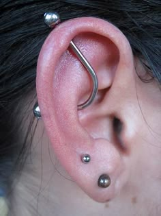 an ear with two piercings attached to it