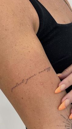 a woman's arm with an inscription on it