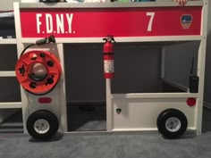 a child's bunk bed with wheels and a fire extinguisher on top