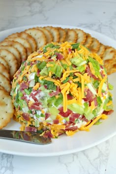 a white plate topped with a salad and crackers