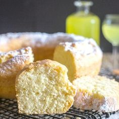 a cake sitting on top of a cooling rack next to a glass filled with liquid