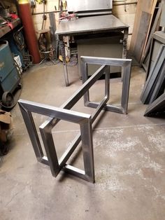 three metal tables sitting in a garage next to each other