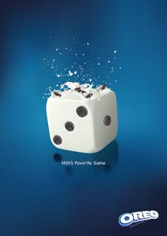 a dice that is falling into the air with milk on it's side and splashing around