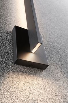 a close up of a wall light on the ground with no one in it's place