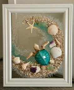 a frame with shells and starfish in it