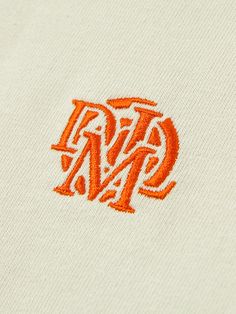 an orange and white monogrammed t - shirt with the letters dm on it