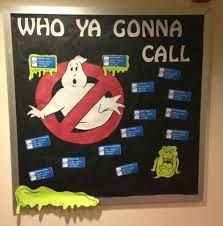 a sign that says who ya gona call with ghost pictures on the wall behind it