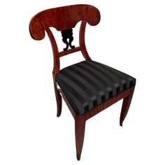 a wooden chair with black leather upholstered seat