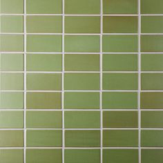 a green tiled wall with white lines on it