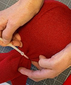 a person is cutting fabric with scissors