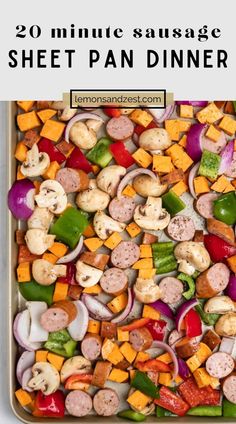 a sheet pan filled with sausages, peppers, and other veggies for dinner